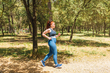 young amateur athlete, jogging in a public park to keep his body healthy. athlete practising sport outdoors. health and wellness lifestyle.