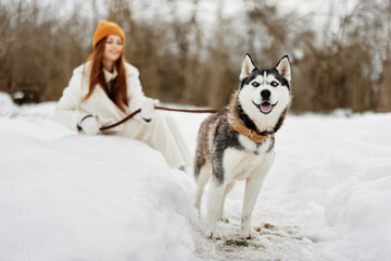 woman outdoors in a field in winter walking with a dog winter holidays