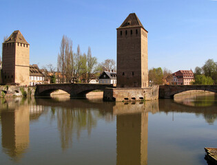 View of the fortress of Strasbourg and the river Ile, reflection in the water, spring, blossoming trees, old houses, April, spring, France, 2009