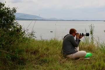 photographer in action in africa Ruanda with a canon dslr and CANON EF 100-400mm f/4.5-5.6L IS II...