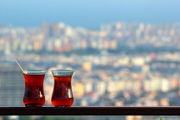 Two bardaks, traditional glasses with hot turkish tea in an outdoor cafe overlooking Antalya...