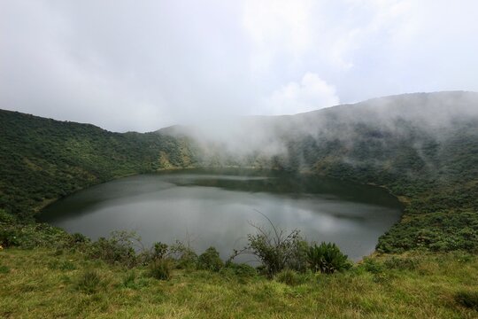 rainbow in the fog crater lake bisoke volcano in rwanda 