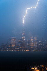 Naklejka na ściany i meble A bolt of lightning strikes One World Trade Center in New York City.