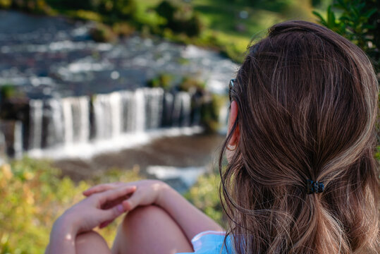 woman at the waterfalls admiring the view