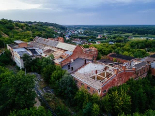 Fototapeten Verlassene Gebäude Ruined overgrown abandoned sugar factory in Ramon, aerial view  © Mulderphoto