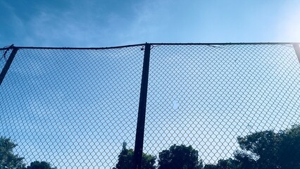 A sport fence and a blue sky in the morning