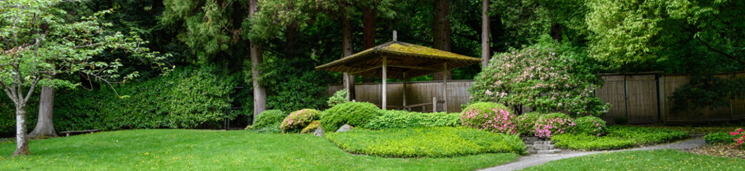 Fototapeta na wymiar Path up to a gazebo in a peaceful Japanese, on a wet spring day 