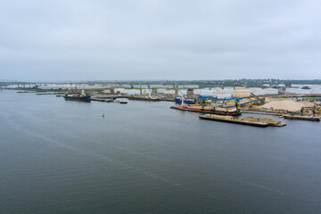 Fototapeta na wymiar Aerial top view the oil tanker ship platforms with unloading at port near oil storage