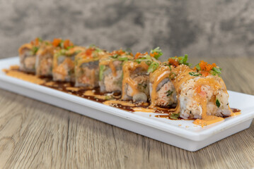 Asian cuisine sushi roll with spicy crab mixed with krab meat and topped with avocado and salmon...