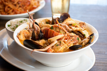 A bowl of sea food soup with rice