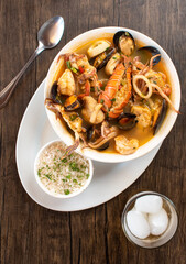 A bowl of sea food soup with rice