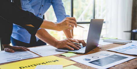 Business people meeting explaining the financial graph data and marketing plan. Group of business people at meeting assessment the state of business investment and marketing.