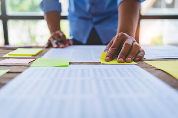 Business people meeting at office and use sticky notes on glass wall in office, diverse employees people group planning work together brainstorm strategy.