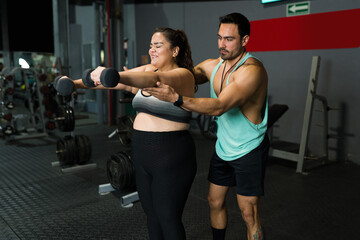 Fototapeta na wymiar Exhausted fat woman doing weight training