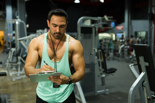 Attractive fitness coach working at the gym