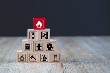 Cube wooden block stack with fire prevent icon and door exit sing or fire escape with fire...