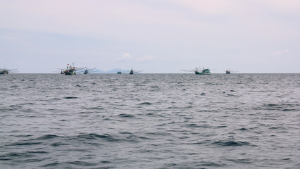 Fishing boats floating in the calm seas are a way of life in Asia.