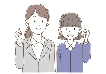 ガッツポーズをしている先生と制服姿の生徒