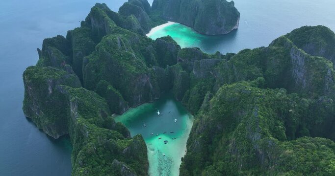 Aerial view of Phi Phi islands Travel Landmark of Krabi Phuket, Thailand. Amazing Drone footage over Maya beach with beautiful blue turquoise seawater. Tourist attraction in summer holidays.
