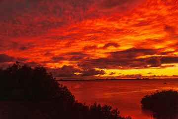 Fototapeta na wymiar Red sunset sky over the bay ocean beautful evening landscape
