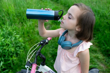a child girl has damaged a bicycle wheel and is making repairs photo without processing. High quality photo