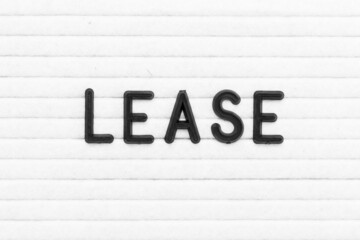 Black color letter in word lease on white felt board background
