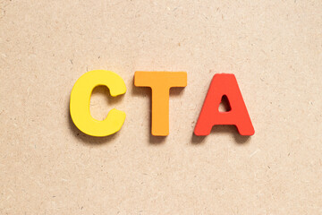 Color alphabet letter in word CTA (Abbreviation of Call to action or Chartered tax adviser) on wood...
