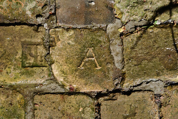 Vintage old wall, stone breaks, symbol A