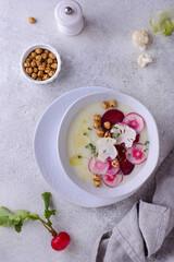 Cauliflower soup puree decorated with radish