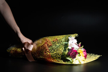 hand holding a bouquet