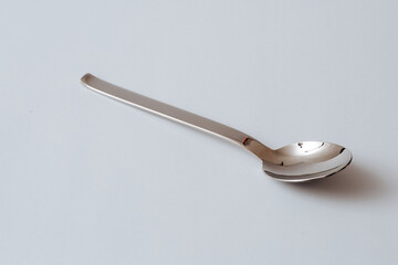 Stainless steel table spoon on white background, copy space