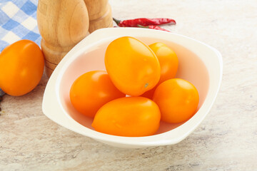 Sweet ripe yellow tomato in the bowl