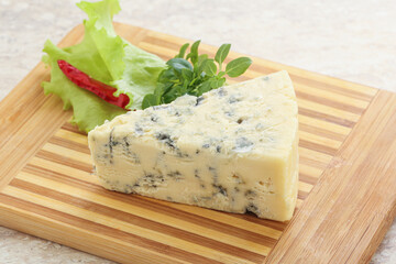 Blue cheese piece over board