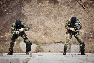 Special forces soldiers in helmets of the Russian army prepare for battle during exercises 