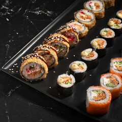 Sushi set. Roll with fresh ingredients on stone background. Top view.
