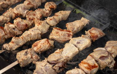 Meat is fried on coals in a brazier.