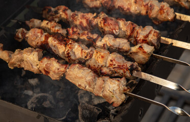 Meat is fried on coals in a brazier.