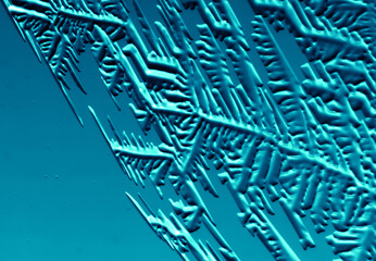 Drawings of ice on blue glass.