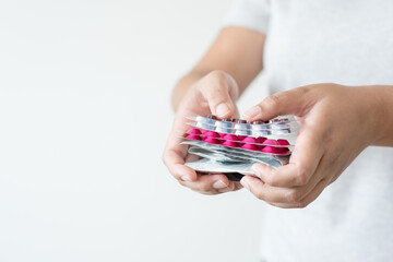 Many colorful pills in woman hand. Concept of medicine and supplement in hospital and medical business.