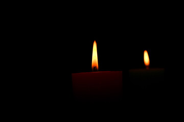 burning candle on black