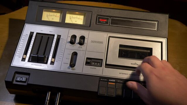 Putting a cassette tape in a 1977 vintage audio tape recorder
