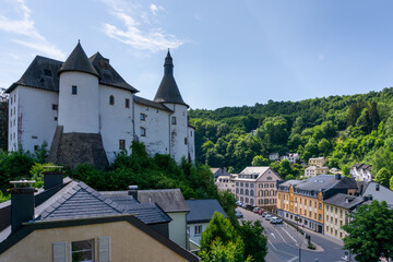 view of the picturesque and historic city center of Clervaux with castle and church in northern Luxembourg - obrazy, fototapety, plakaty