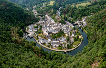 drone view of the picturesque village of Esch-sur-Sure on the Sauer River in northern Luxembourg - obrazy, fototapety, plakaty