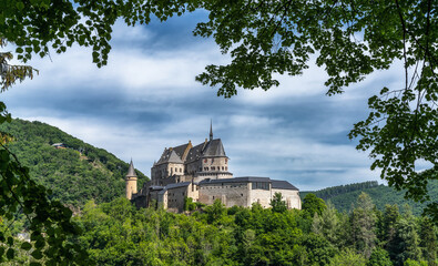 Fototapeta na wymiar the historic Vianden Castle in Luxembourg framed by lush green summer forest