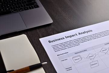 There is dummy documents on the desk about Business Impact Analysis.