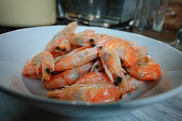 Fried king prawns in a white plate in the kitchen