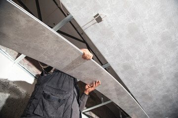 Construction worker assemble a suspended ceiling.