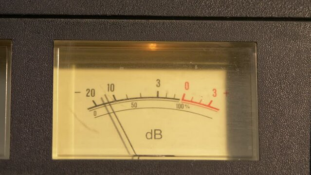 Sliding shot of a VU meter to a "record" light on a vintage cassette player