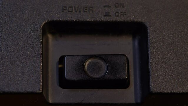 Turning on and off the power button on a vintage audio player