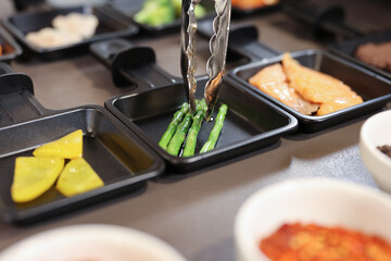 portion cooking vegetables, meat, fish, broccoli, asparagus in the kitchen
